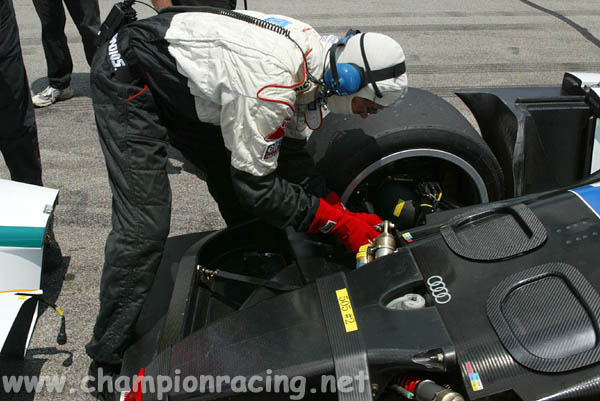 Bill Braucksick adjusts the suspension on the Champion Racing Audi R8 American Le Mans race car. (Courtesy Champion Racing)
